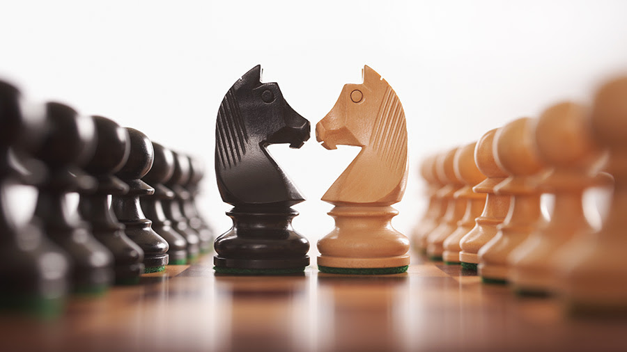 Black White Knight Chess Pieces Facing Off